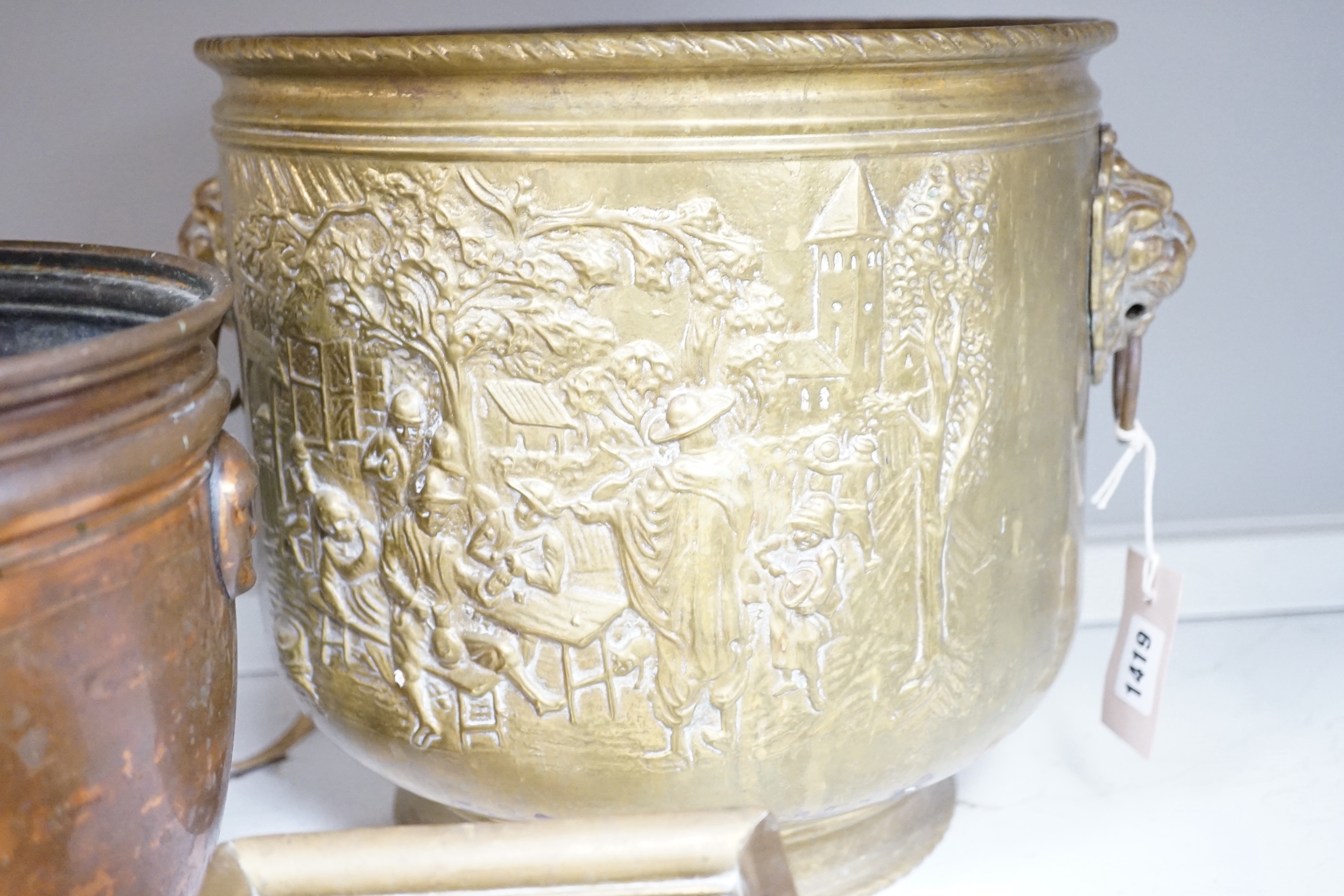A group of metalware including two jardinieres, two brass dishes, a brass horses, head tray, a bronze of two jockeys on horseback and a bronze of a seated horse, tallest jardiniere 29cm